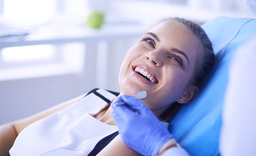 Smiling woman in dentist’s chair
